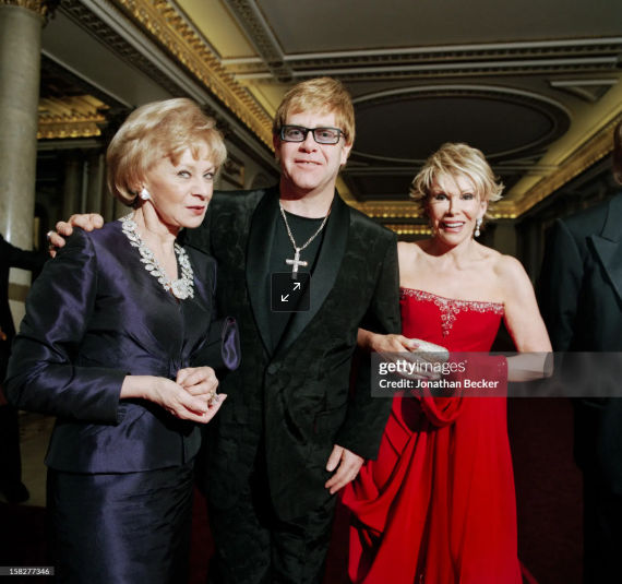 Lily Safra, Elton John and Joan Rivers photographed for Vanity Fair at Buckingham Palace, London, June 21, 2003