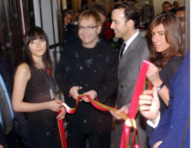 Sir Elton John and David Furnish cutting the ribbon to launch Out of the Closet IV charity sale on Regent Street, London, December 4, 2002