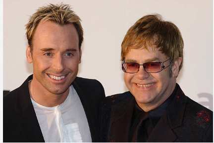 British singer Sir Elton John and David Furnish at the amfAR benefit party near Cannes, May 23, 2002