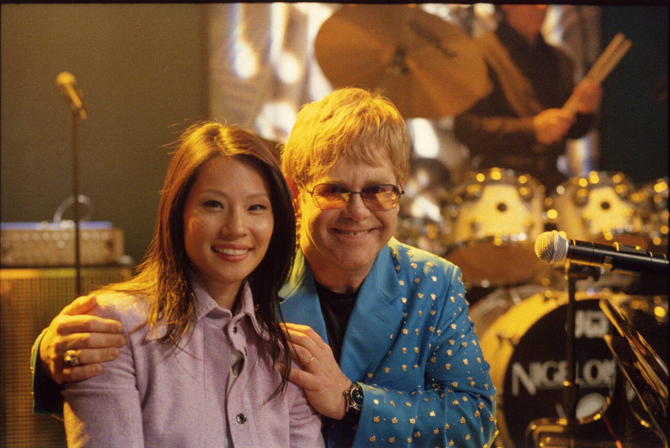 Ally McBeal publicity still featuring Elton John and Lucy Liu