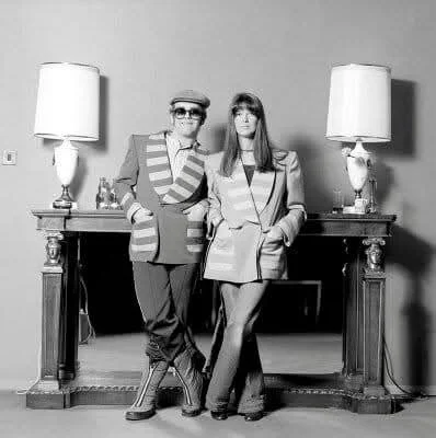 Elton John and writer Frankie McGowan wearing a matching jacket, photographed in London, 1977