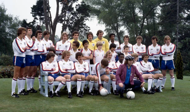 Elton John With The England Football Team Elton John poses with the England Football Team and some young prize winners, circa 1979.