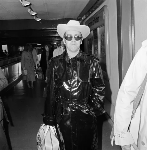 Elton John leaving Heathrow Airport for Los Angeles, where he will be recording a new album. 9th January 1980.