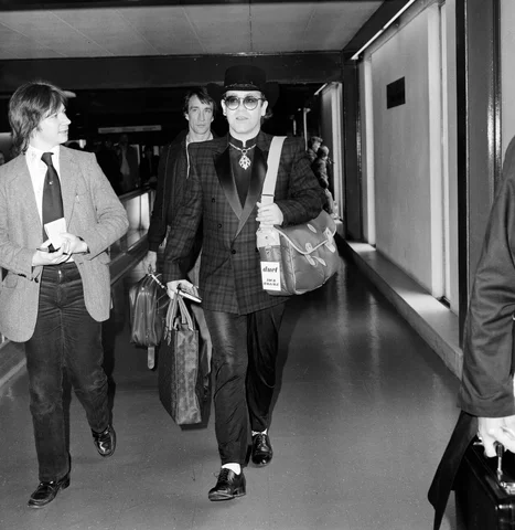 Elton John leaving Heathrow Airport for Los Angeles. 6th April 1981.