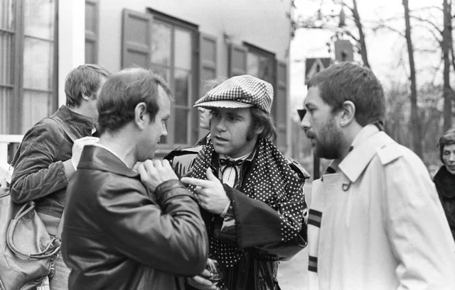 Elton John. English singer, songwriter born march 25 1947. Pictured wearing a chequered cap and a matching chequered scarf during a visit to Sweden 1978