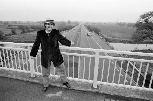 elton john pictured standing on a bridge over the motorway 5th december 1982