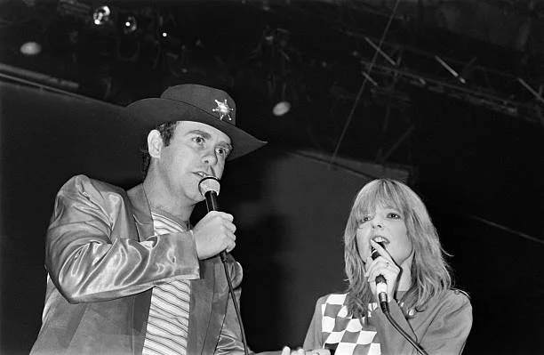 French singer France Gall (R) and British musician Elton John perform on the Palais des Sports concert hall stage, on January 22, 1982