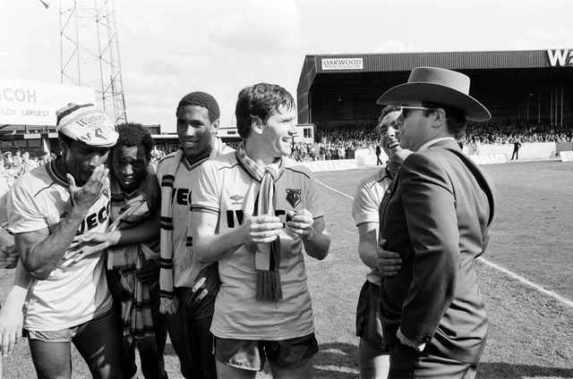 Elton John and some of the Watford side after their match against Liverpool. 14th May 1983.