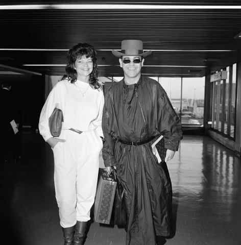 Elton John and his new wife Renate arriving at Heathrow Airport from Hong Kong, 2nd April 1984.
