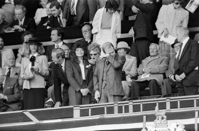 Watford chairman Elton John sheds a tear. His new wife Renate soaks up the atmosphere. And one lady looks very bored with 90 minutes still to go. The 1984 FA Cup Final at Wembley Stadium. Final score Everton 2 v Watford FC 0. 19th May 1984.