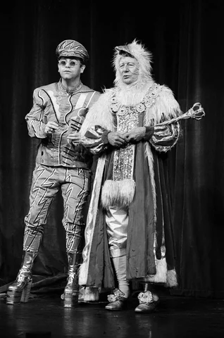 Elton John brings the house down in a charity show at London's Theatre Royal. He also teamed up with Sir John Gielgud for a duet. Sir John was in a little known role - Egg Yolk the First, a king of geese. 2nd December 1984.