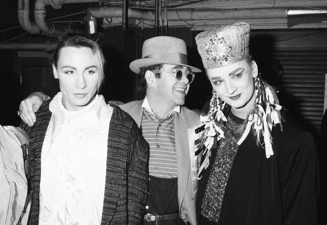 ••• Singer Boy George with with friend Marilyn and Elton John during the Culture Club concert at Wembley.22nd December 1984.