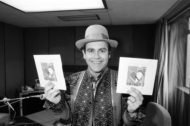 Elton John at BRMB Radio Aston, Birmingham. The visit was to promote his latest single, "Breaking Hearts (Ain't What It Used To Be)" and to also chat to his fans in the Midlands. 22nd February 1985.2