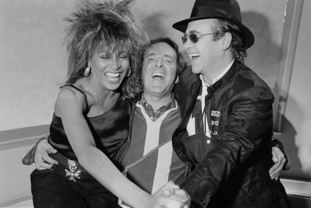 Tina, Terry And Elton From left to right, singer Tina Turner, chat show host Terry Wogan and singer and pianist Elton John at the BBC Television Centre in Shepherd's Bush, London, 18th February 1985. Turner and John are appearing on the chat show 'Wogan'.