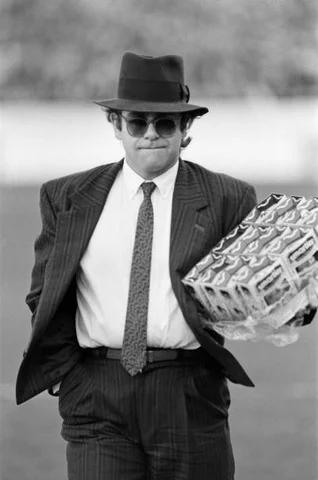 Elton John handing out easter eggs Pop star and Watford FC Chairman, Elton John, handing out Easter eggs to fans. Watford v Southampton football match, 6th April 1985.