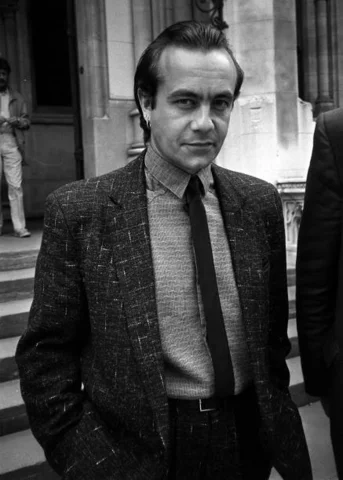 BERNIE TAUPIN : ELTON JOHN CO-WRITER 1985: Elton John's songwriting partner, Bernie Taupin, in London for the High Court hearing in which he and the singer are suing music publisher Dick James for a bigger share of the takings from Elton's early records.