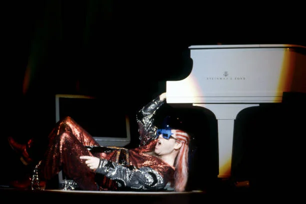DETROIT - AUGUST 17: English singer, songwriter, pianist and composer, Sir Elton John, performs at Pine Knob Music Thater, on August 17, 1986, in Clarkston, Michigan