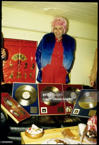Elton John with gold records, Zurich, Switzerland, March 31, 1986