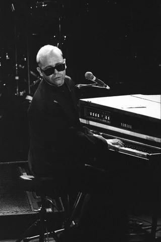Elton John performing at the Stand by Me: AIDS Day Benefit concert at Wembley Arena, London. 1st April 1987.