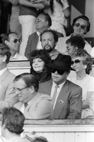 Elton John and his wife Renate watching the Watford v Tottenham Hotspur match. Final score 1-0 to Watford. League Division One. 9th May 1987.