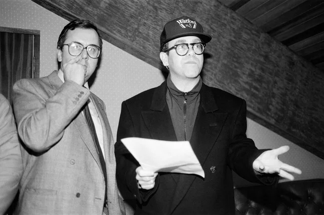 Elton John, pictured speaking to press about the sale of Watford Football Club. 26th November 1987.