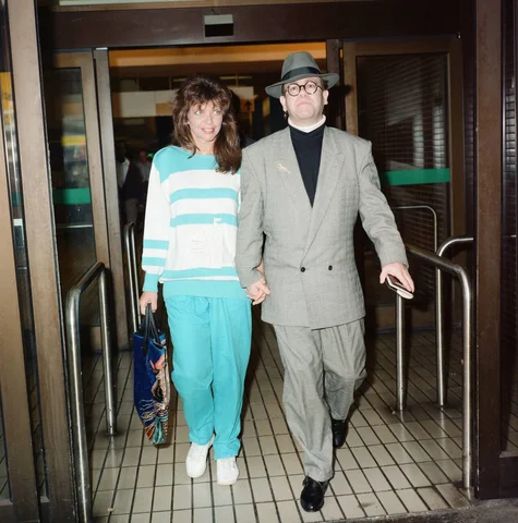 Elton John and his wife Renate at London Airport. 29th July 1988.