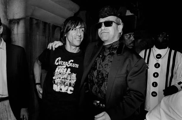 Iggy Pop (left) and British Pop & Rock musician Elton John at an unspecified nightclub,