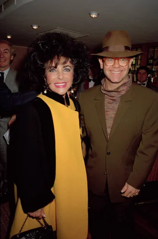 Elizabeth Taylor And Elton John British and American actress Elizabeth Taylor with British singer Elton John at a charity event for the Aids Crisis Trust, London, November 1991.
