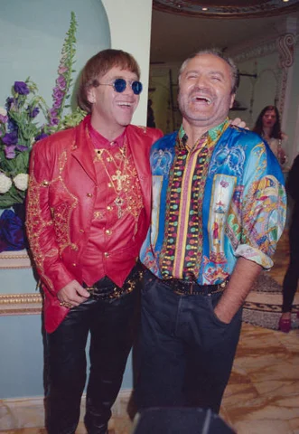 Gianni And John Fashion designer Gianni Versace enjoys a joke with singer Elton John at the opening of the new Versace shop, 28th May 1992