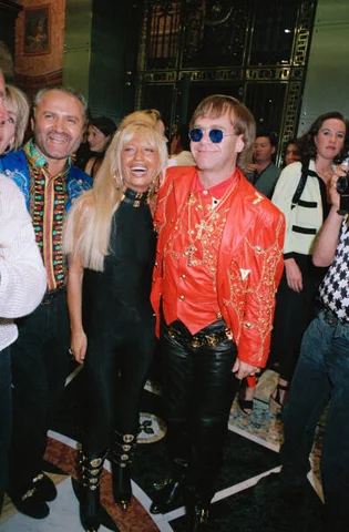 Elton And Versaces English pop star Elton John with Gianni and Donatella Versace at the opening of Versace's new store, 28th May 1992.