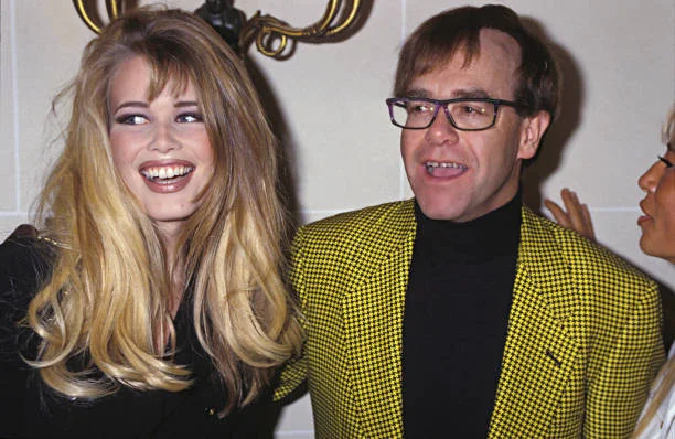 Portrait of model Claudia Schiffer and singer Elton John