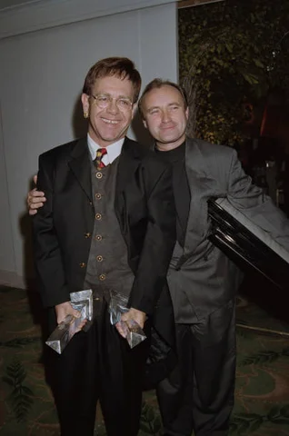 British singers Elton John (left) and Phil Collins attend the American Society of Composers, Authors, and Publishers (ASCAP) awards in London, 17th September 1993.