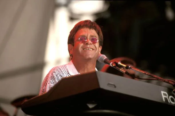 Sir Elton Hercules John is shown performing on stage during a live concert appearance on September 6, 1993 in Foxboro, Massachusetts.