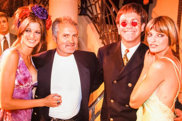 Gianni Versace, Elton John, and Linda Evangelista at the Versace Haute Couture Autumn/Winter 1993–1994 fashion show in Paris, France, on July 18, 1993.