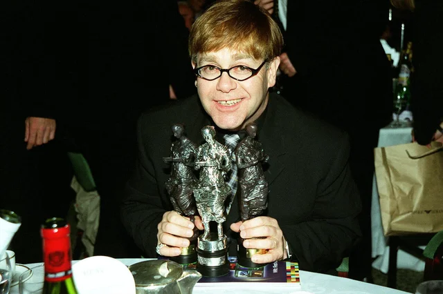 Elton John Singer June 98 At the Ivor Novello Awards 1998 at the Grosvenor House Park Lane London with his award for International Hit Of The Year with Candle In The Wind 1997