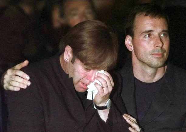 British pop star Elton John (L) is comforted by his friend David Surshine ashe weeps during a requiem mass for Italian fashion designer Gianni Versace at the Milan Duomo 22 July. Versace was gunned down in Miami Beach 15 July.