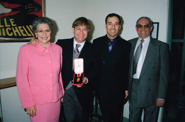 Elton John with his mother Sheila Farebrother, his stepfather and his partner David Furnish, after receiving his knighthood in London, 24th February 1998