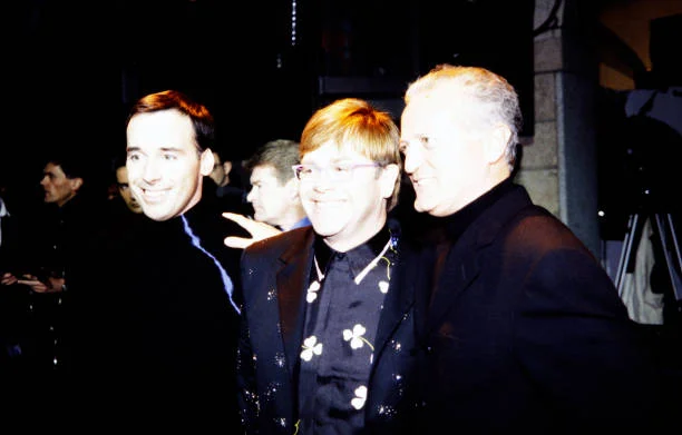 Date: January 18, 1998 Location: Paris, France Event: Versace Fall 1998 Ready-to-Wear Menswear Runway Show and Backstage Attendees: Santo Versace, Elton John, David Furnish
